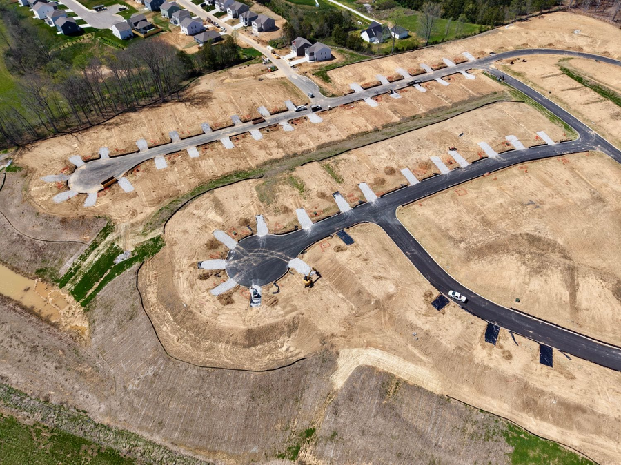 Aerial view of a graded residential subdivision with paved streets and cul-de-sacs