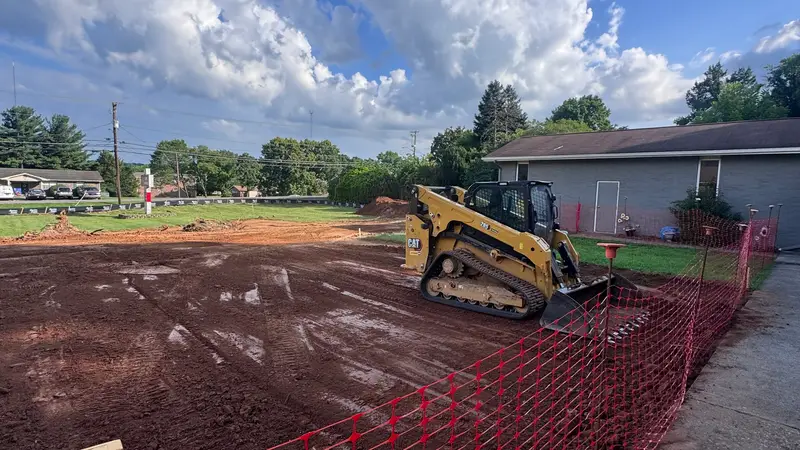 Skid steer grading the building pad at Life Church Worship Center in Knoxville